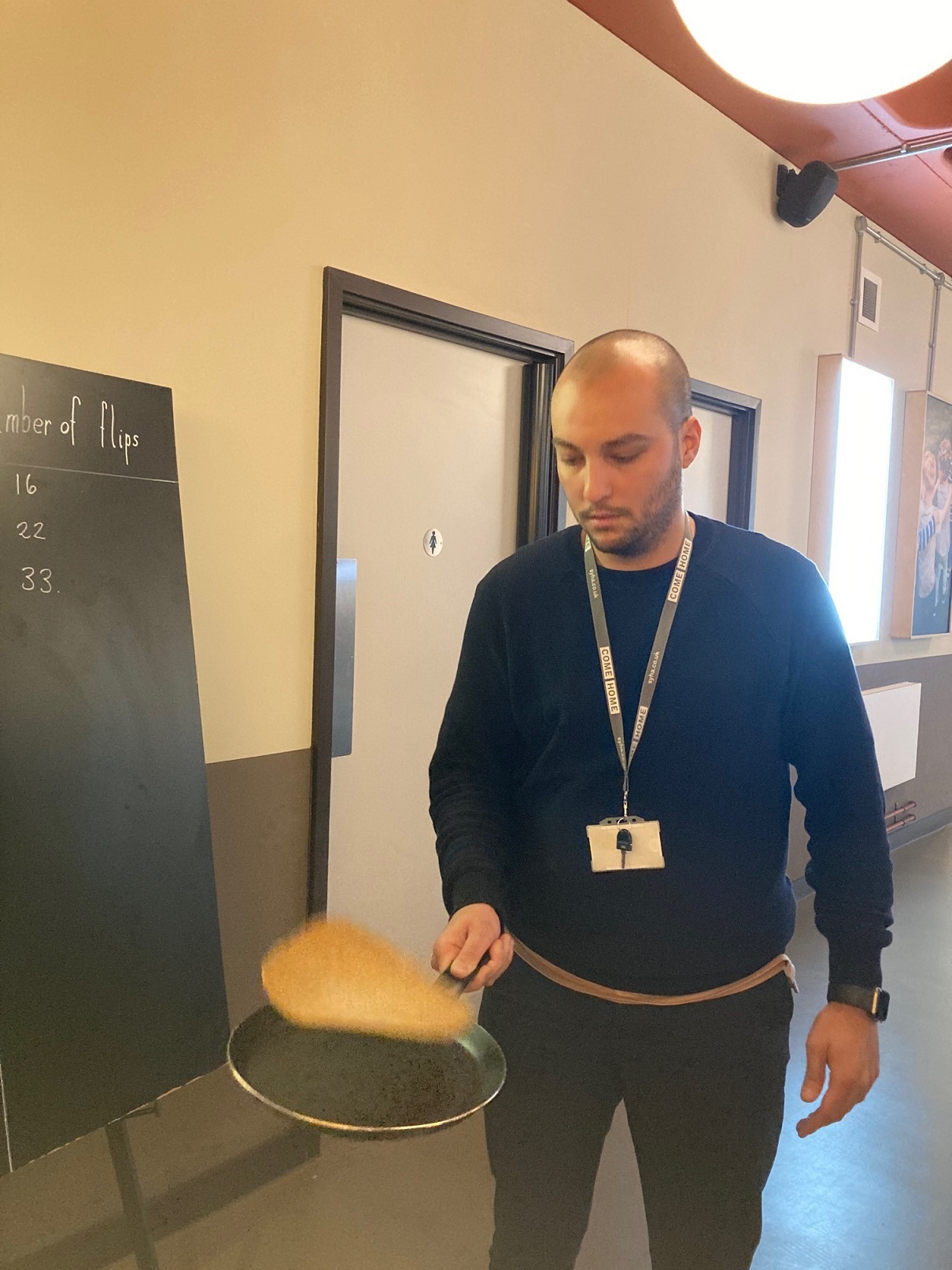 Matteo flipping pancakes at our GiveWell fundraising event.