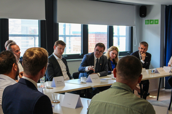 A photo of Mel Stride in our Rockingham Street office. He's sat at a table with other people in the meeting.