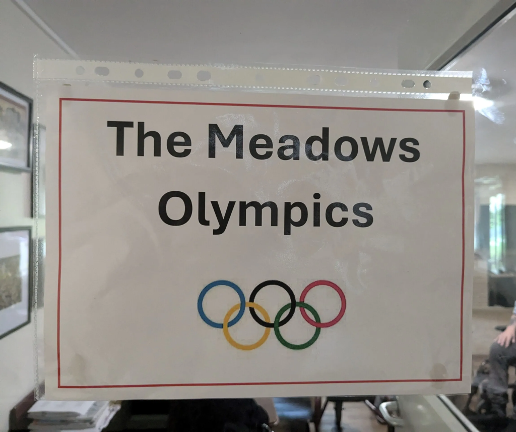 Picture of a sign advertising The Meadows Olympics event at the Meadows